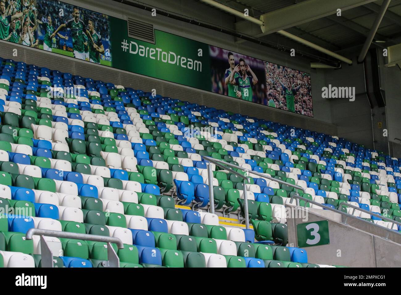 Angled rows of modern plastic tip-up seats in UK football ground. Empty seating Windsor Park, Belfast. Stock Photo