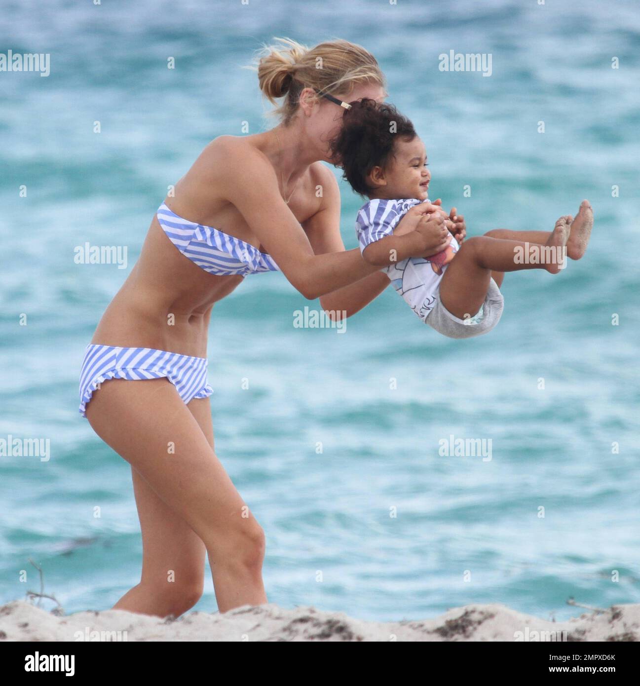 EXCLUSIVE!! Beautiful model mom, Doutzen Kroes, spends Valentines Day at  the beach with her infant son Phyllon Joy GorrŽ. The cute duo played in the  sand by the water's edge while Phyllon