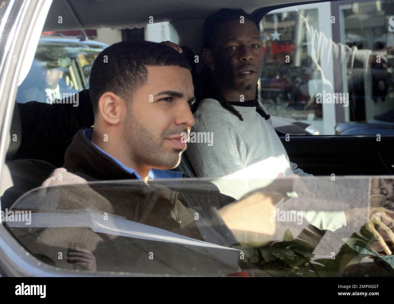EXCLUSIVE!! Canadian recording artist and actor Aubrey 'Drake' Graham, better known as Drake, was seen having lunch at a restaurant in Beverly Hills. The actor who originally became known for the role of Jimmy Brooks on the TV series, 'Degrassi: The Next Generation,' appeared to have gotten fed up with the photographers and flashed them the finger as he drove off in his chauffeur driven vehicle. Its been reported that Drake and Justin Bieber will be hitting the recording studio in January to collaborate on a track for Bieber's new album, 'Believe.' When describing Bieber's musical abilities, D Stock Photo