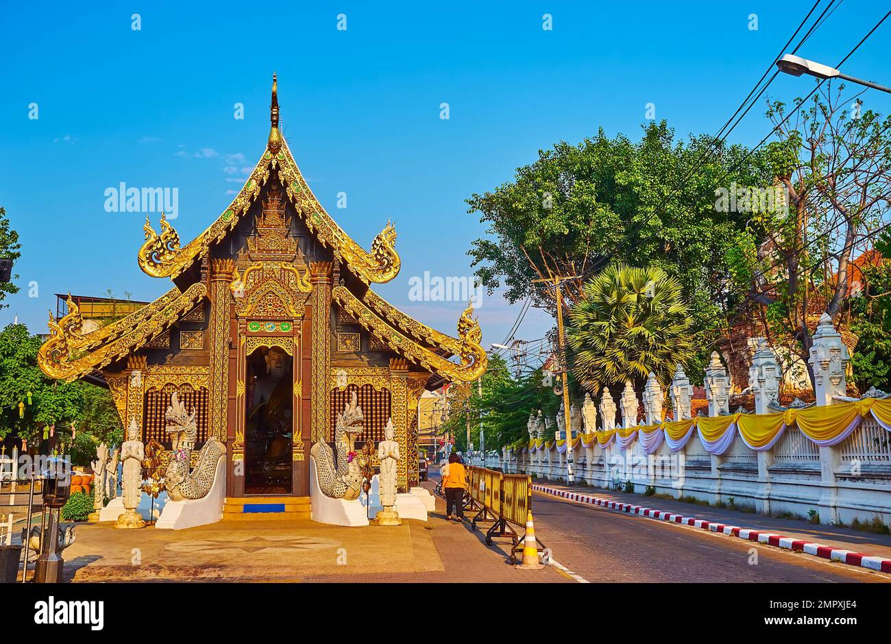 The richly decorated historic facade of Viharn of Wat Inthakhin Sadue Muang Temple, decorated with Naga serpents, carved and gilt wooden details, barg Stock Photo