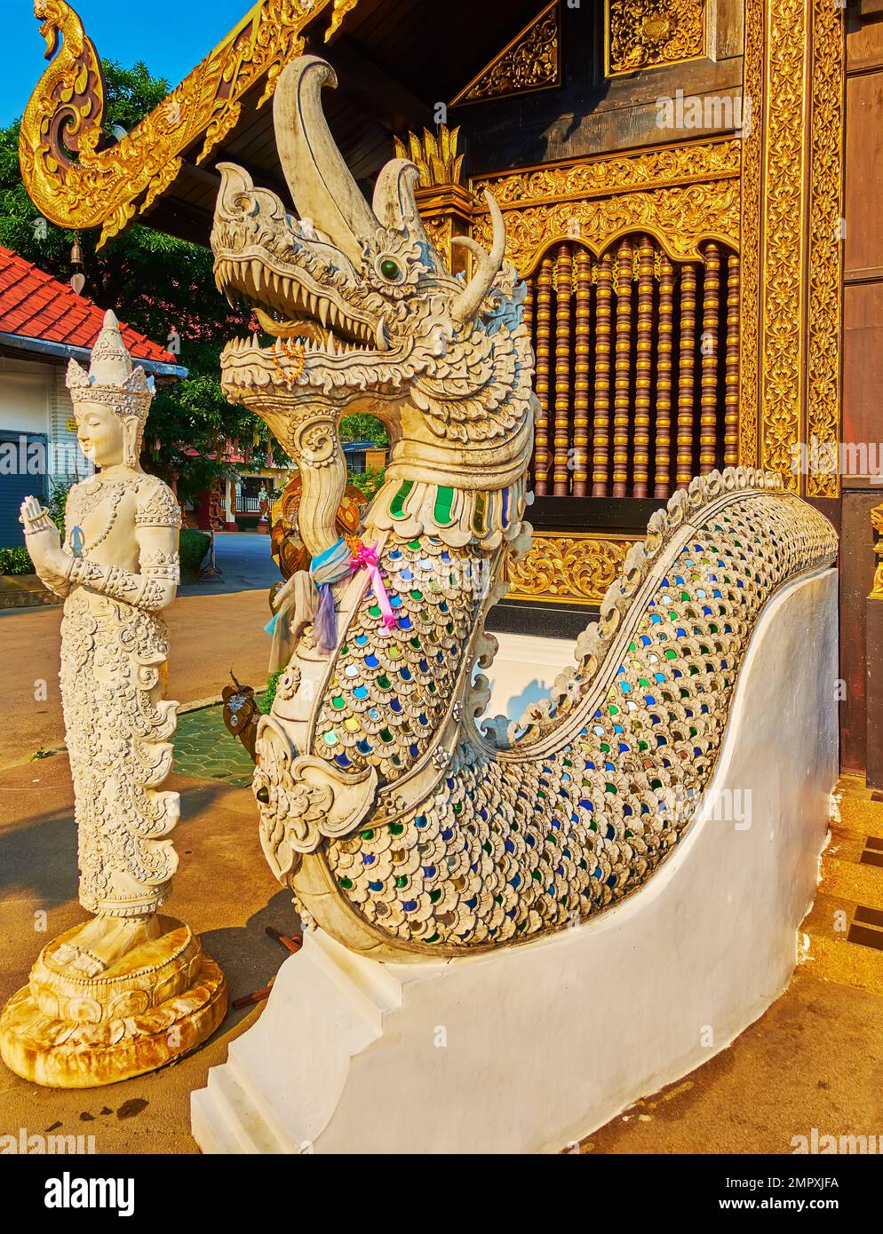 Historic statues of Naga serpent and Devata deity, guarding the entrance to the Wat Inthakhin Sadue Muang temple, Chiang Mai, Thailand Stock Photo