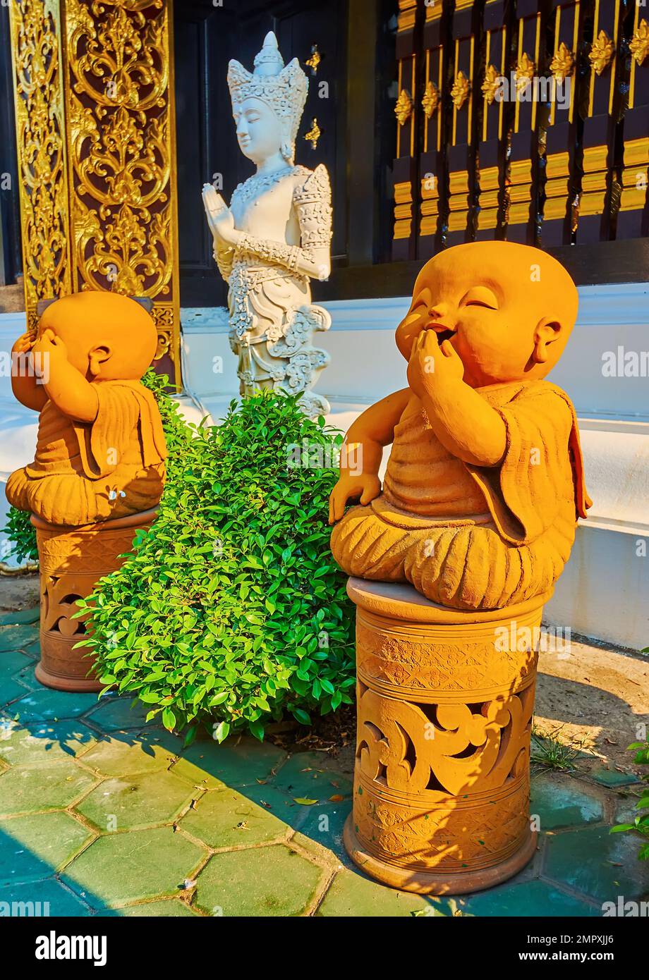 The ochre statues of Hear See Speak No Evil Baby Buddha, located at the ...