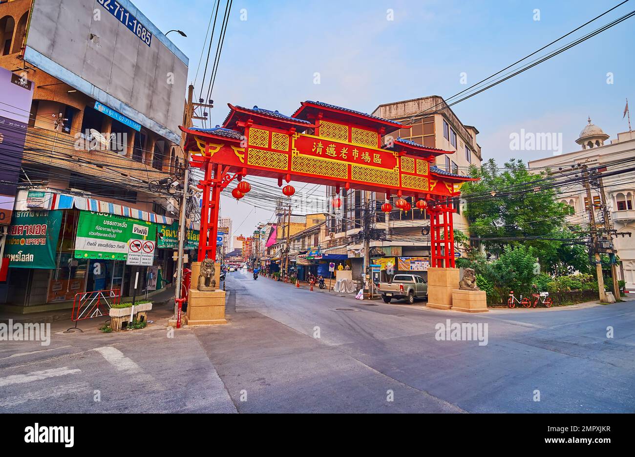 CHIANG MAI, THAILAND - MAY 3, 2019: The red Chinese Welcome Gate, decorated with gilt inscription, patterns and lanterns, located at the entrance to t Stock Photo