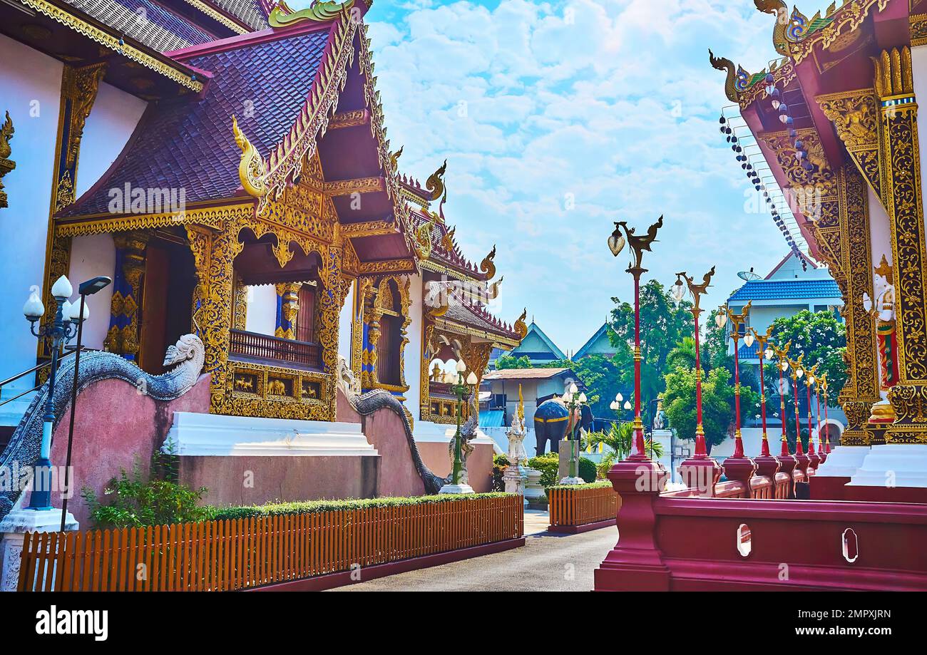 The richly decorated Viharn of Wat Saen Muang Ma temple with gilt stucco patterns, Naga serpents sculptures and traditional pyathat roof, Chiang Mai, Stock Photo