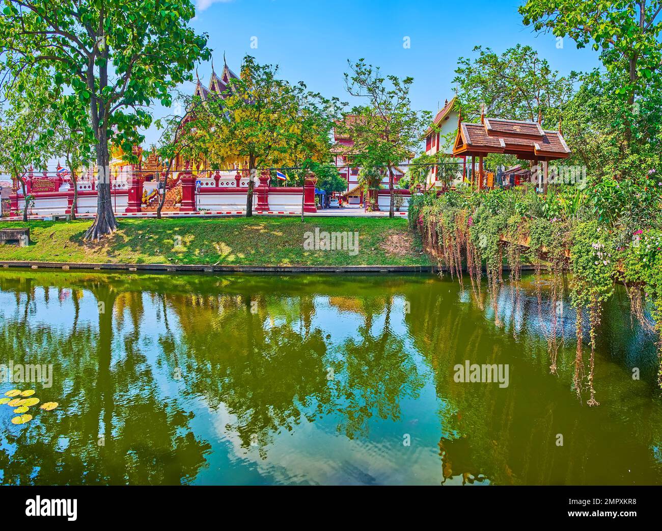 The lush hanging plants decorate the wooden footbridge across the Old City Moat, Chiang Mai, Thailand Stock Photo