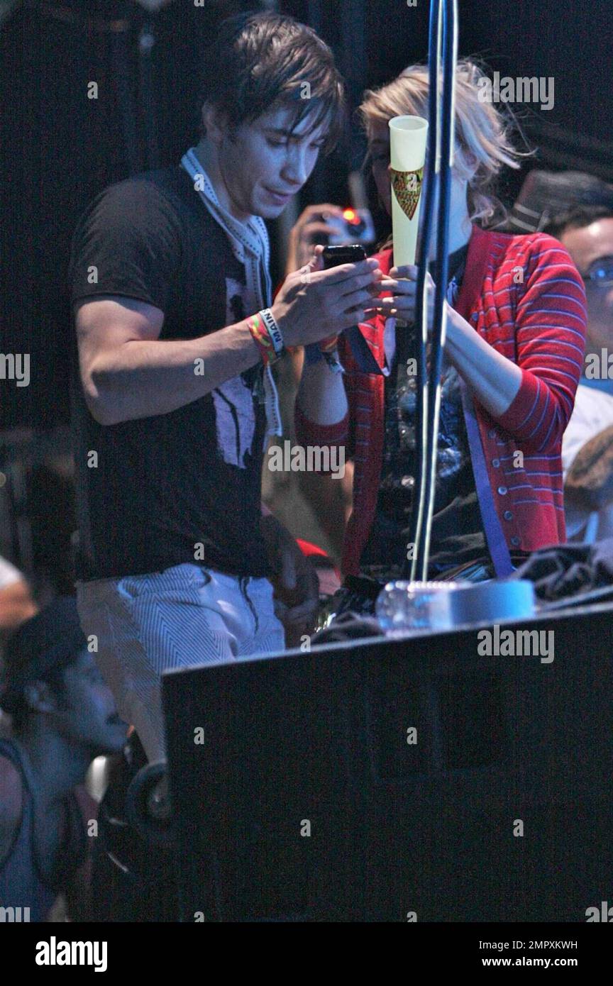 Drew Barrymore and recently reconciled boyfriend Justin Long watch the M.I.A concert.  Long took pictures of Barrymore on his iphone before she appeared up onstage during the concert throwing glow sticks into the audience at Coachella Music and Arts Festival 2009. Indio,CA. 04/18/2009.    . Stock Photo