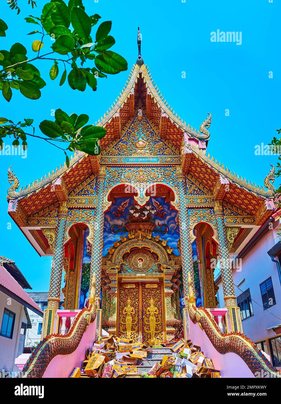 CHIANG MAI, THAILAND - MAY 3, 2019: Ornate exterior of the Ubosot of Wat Dap Phai with Naga statues, Devata deitises on the doors, colored murals on w Stock Photo