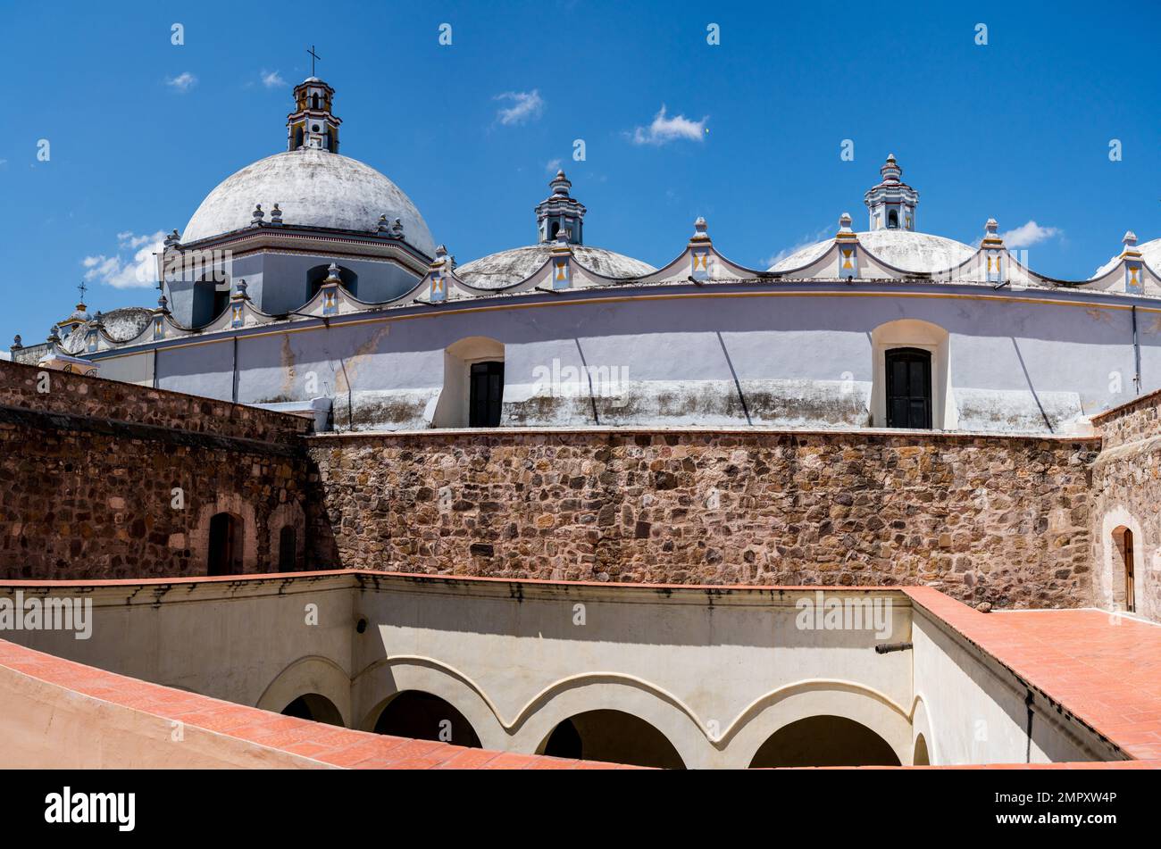 Domes of the Church of Santo Domingo de Guzman in Ocotlan de Morelos, Oaxaca, Mexico.  The monastery is in front. Stock Photo