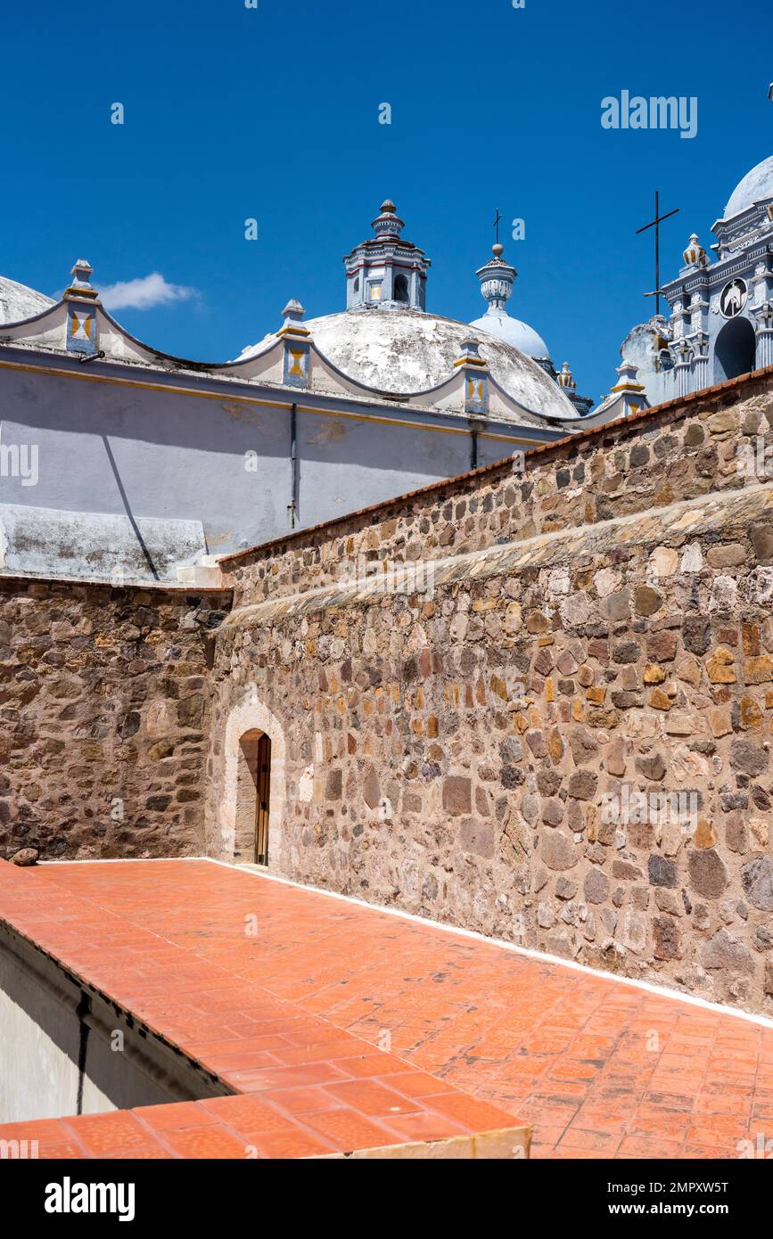 Dome of the Church of Santo Domingo de Guzman in Ocotlan de Morelos, Oaxaca, Mexico with the top of the monastery in front. Stock Photo