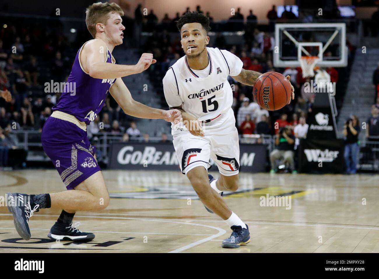 Cincinnati's Cane Broome (15) drives against Western Carolina's Matt