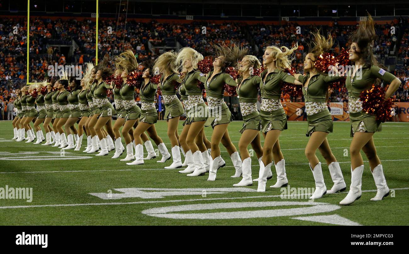 The Denver Broncos cheerleaders wear green to celebrate the NFL's