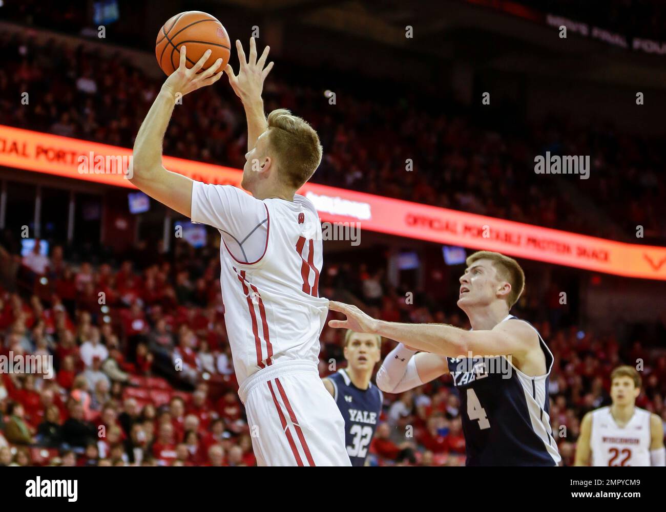 Wisconsin's Andy Van Vliet (11) shoots past Yale's Noah Yates (4