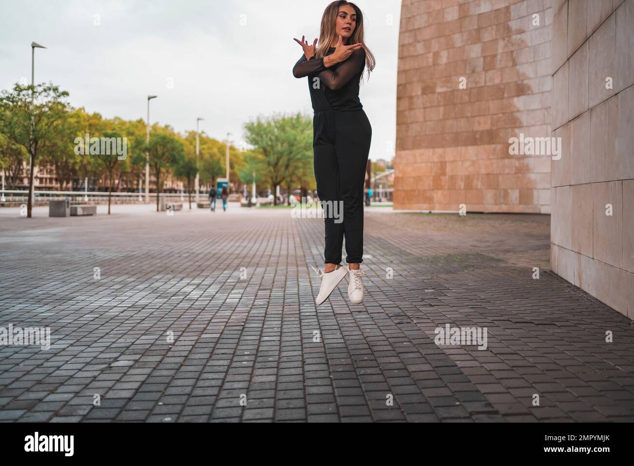 young blonde contemporary dancer dancing on the street. Stock Photo