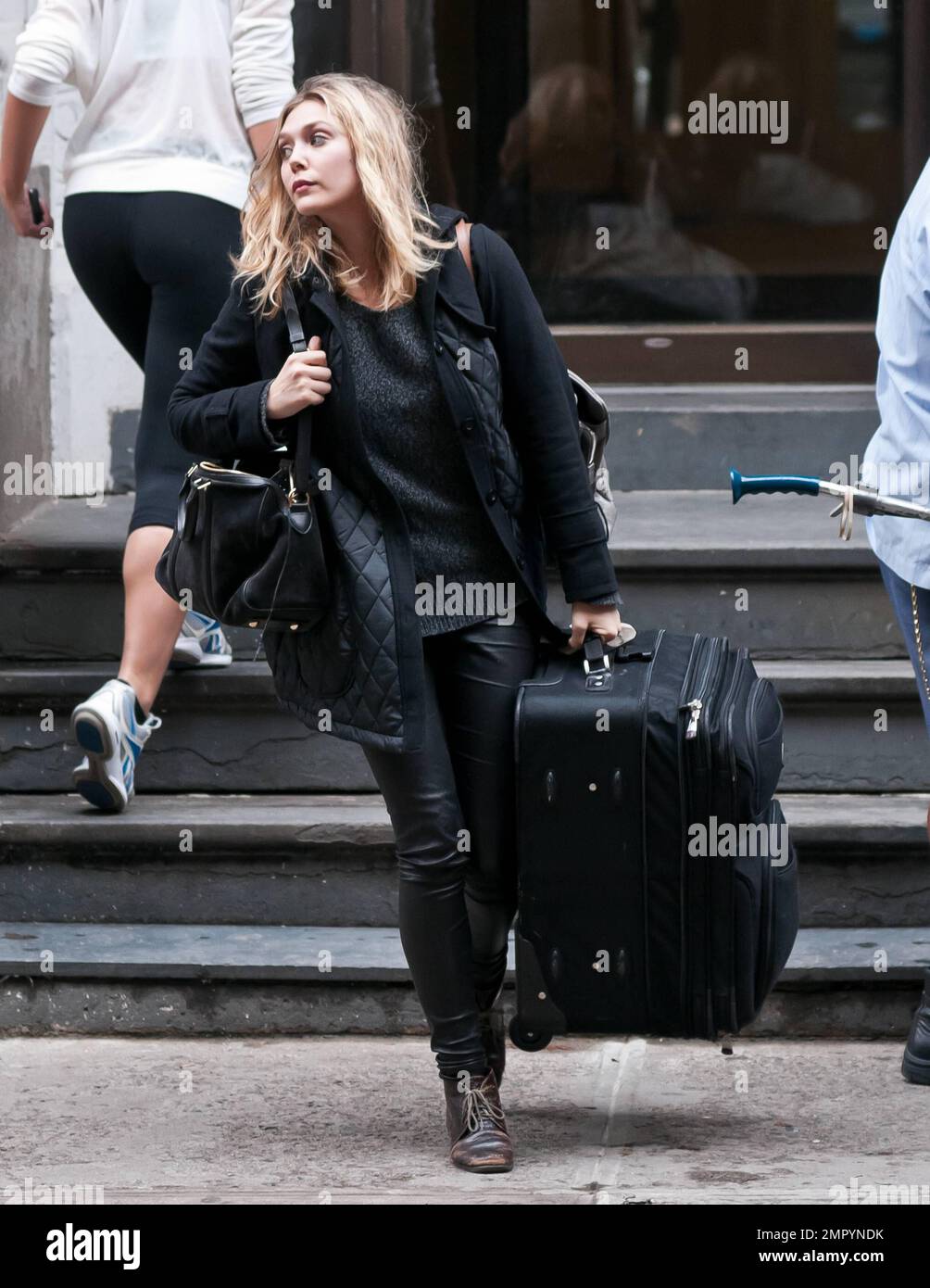 Actress Elizabeth Olsen, younger sister to famous twins Mary-Kate Olsen and Ashley Olsen, was seen departing her West Village apartment with luggage in hand as she made her way to the airport to catch a flight to Los Angeles. It's been reported that Elizabeth has become an overnight starlet with her lead debut in 'Martha Marcy May Marlene' which premiered earlier this week at the New York Film Festival. The film has a limited release date of October 21st and is already generating Oscar buzz. New York, NY. 13th October 2011. Stock Photo