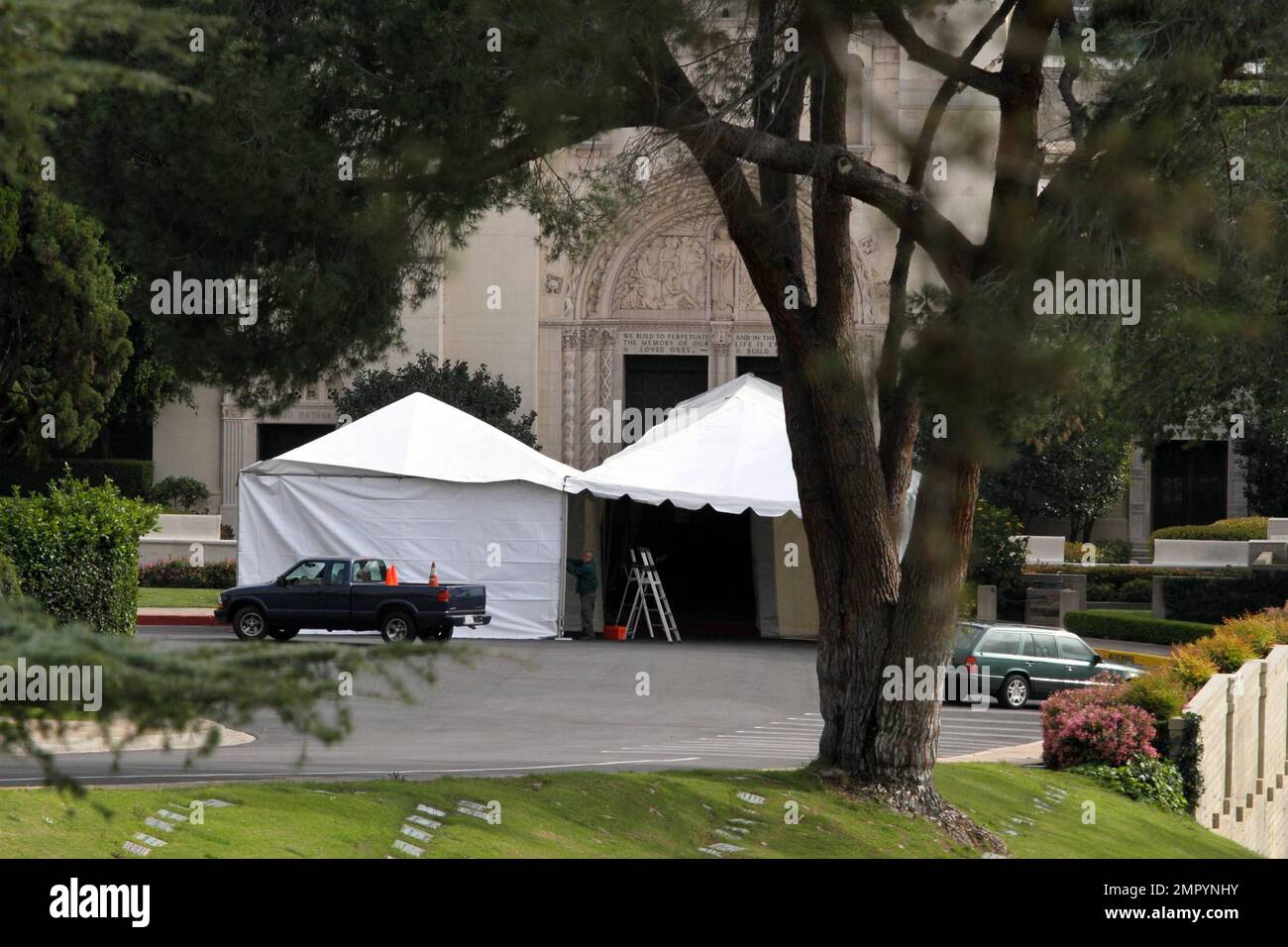 Mourners leave Forest Lawn Memorial Cemetery in limousines after
