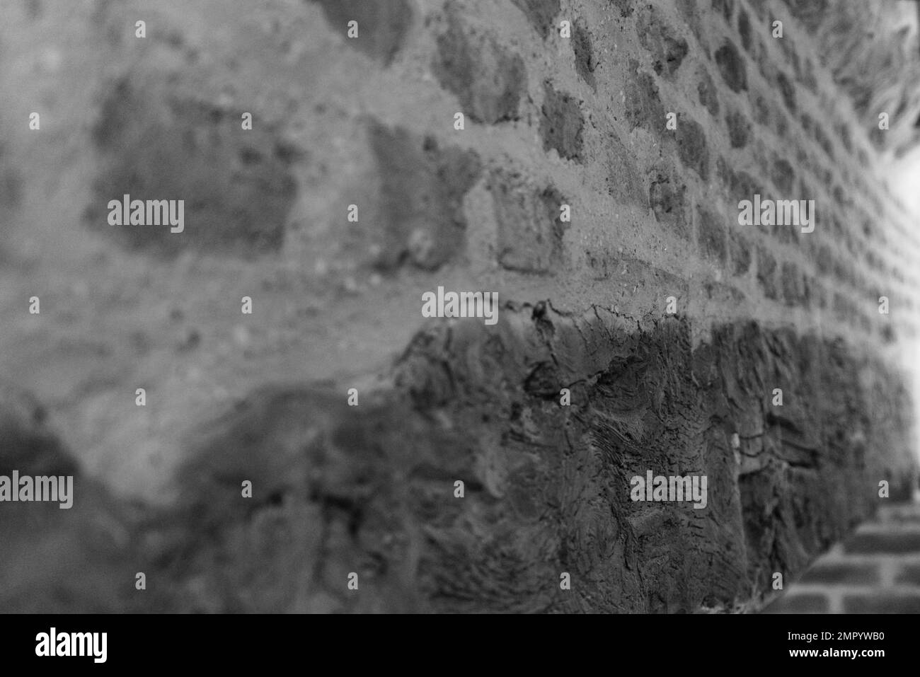 Reclaimed wooden beam and brickwork over a large fireplace Stock Photo