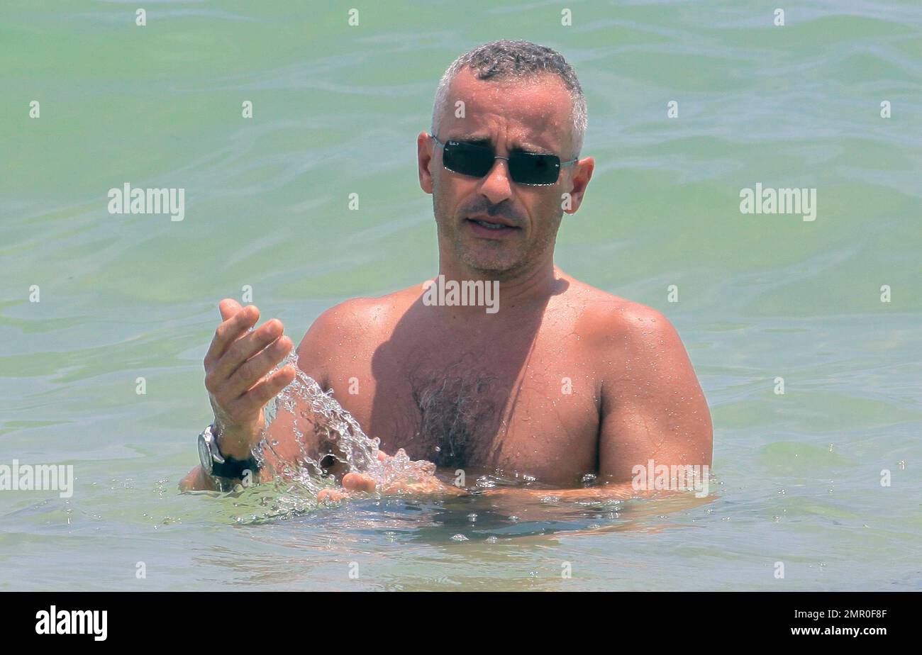 Italian singer Eros Ramazzotti spends a day on the beach with bikini