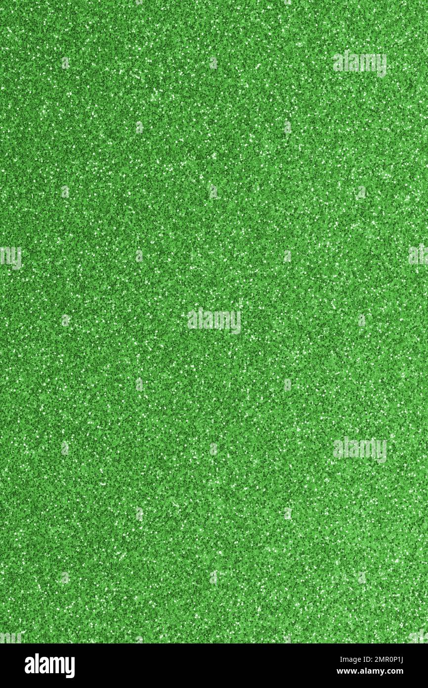 GREEN shimmering glitter material background with glowing effects Stock Photo