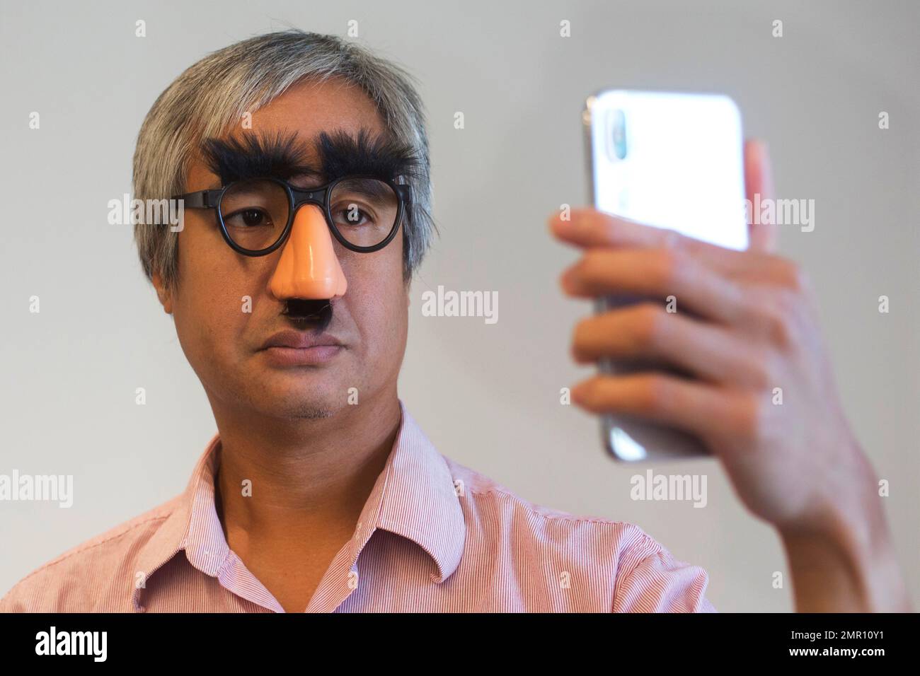 https://c8.alamy.com/comp/2MR10Y1/in-this-monday-oct-30-2017-photo-associated-press-reporter-anick-jesdanun-demonstrates-face-id-apples-name-for-its-facial-recognition-technology-on-an-iphone-x-in-new-york-if-youre-wearing-glasses-the-iphone-can-still-recognize-you-using-other-parts-of-your-face-within-reason-the-iphone-did-not-recognize-jesdanun-with-this-costume-on-ap-photomark-lennihan-2MR10Y1.jpg