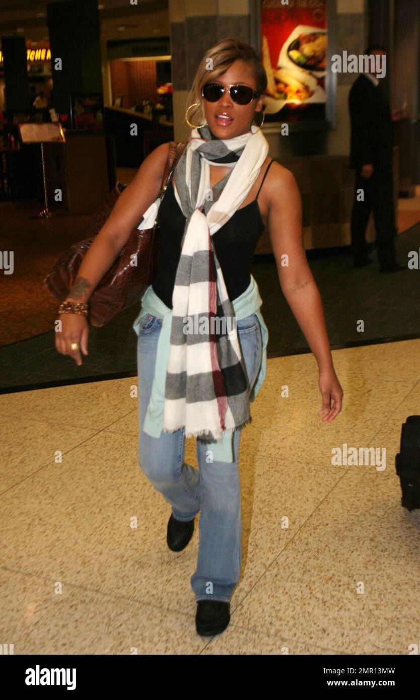 Exclusive!! Rapper Eve arrives at Miami Intl Airport from LAX wearing a  fairly revealing tank top. She flew in to town to attend this weekend's $5  million grand re-opening of the Fountainbleu