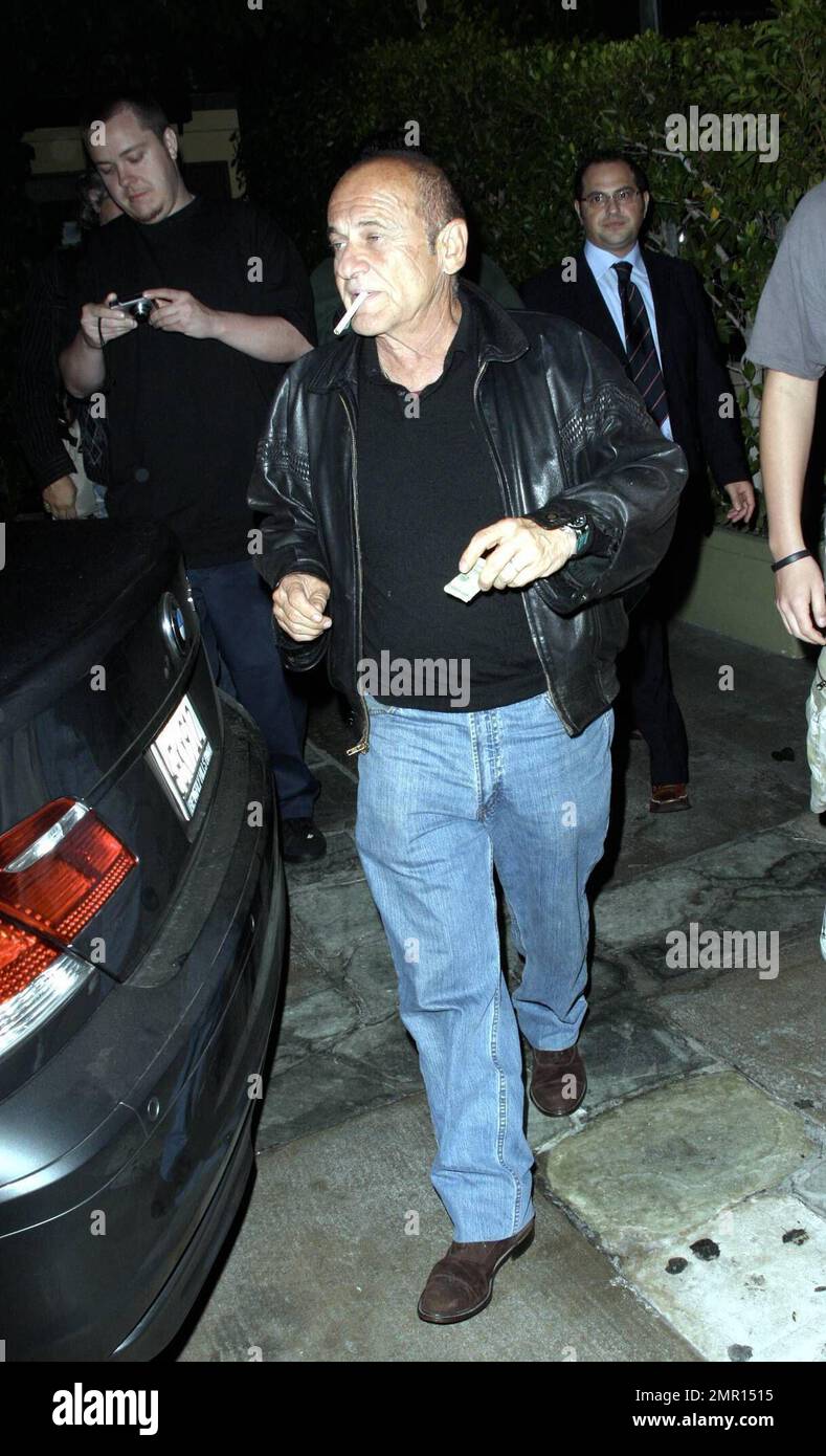 Exclusive!! Joe Pesci and Angie Everhart leave the restaurant AGO. Everhart makes her way quickly to the waiting car, hiding her face as much as possible, but Pesci smokes a cigarette while signing autographs and taking photos with fans. Los Angeles, CA. 10/21/08. Stock Photo