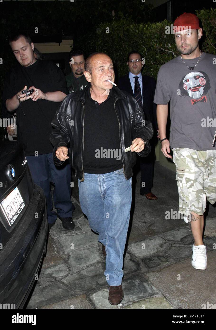 Exclusive!! Joe Pesci and Angie Everhart leave the restaurant AGO. Everhart makes her way quickly to the waiting car, hiding her face as much as possible, but Pesci smokes a cigarette while signing autographs and taking photos with fans. Los Angeles, CA. 10/21/08. All Stock Photo