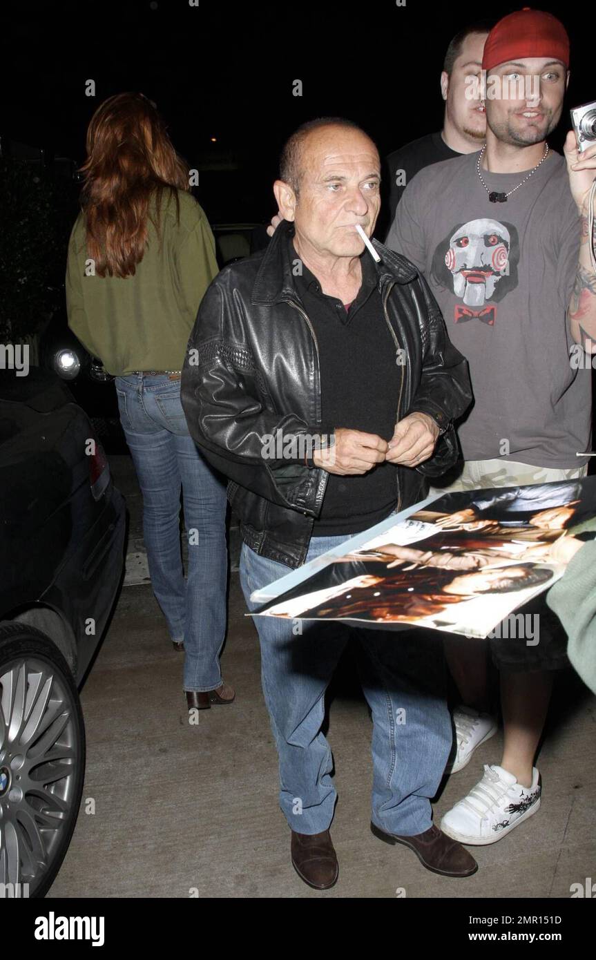 Exclusive!! Joe Pesci and Angie Everhart leave the restaurant AGO. Everhart makes her way quickly to the waiting car, hiding her face as much as possible, but Pesci smokes a cigarette while signing autographs and taking photos with fans. Los Angeles, CA. 10/21/08. All Stock Photo