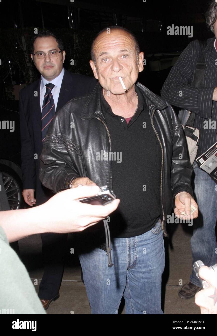 Exclusive!! Joe Pesci and Angie Everhart leave the restaurant AGO. Everhart makes her way quickly to the waiting car, hiding her face as much as possible, but Pesci smokes a cigarette while signing autographs and taking photos with fans. Los Angeles, CA. 10/21/08. Stock Photo