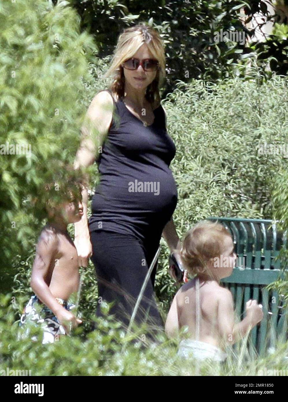 A very pregnant Heidi Klum shows off an accentuated bump in a tight