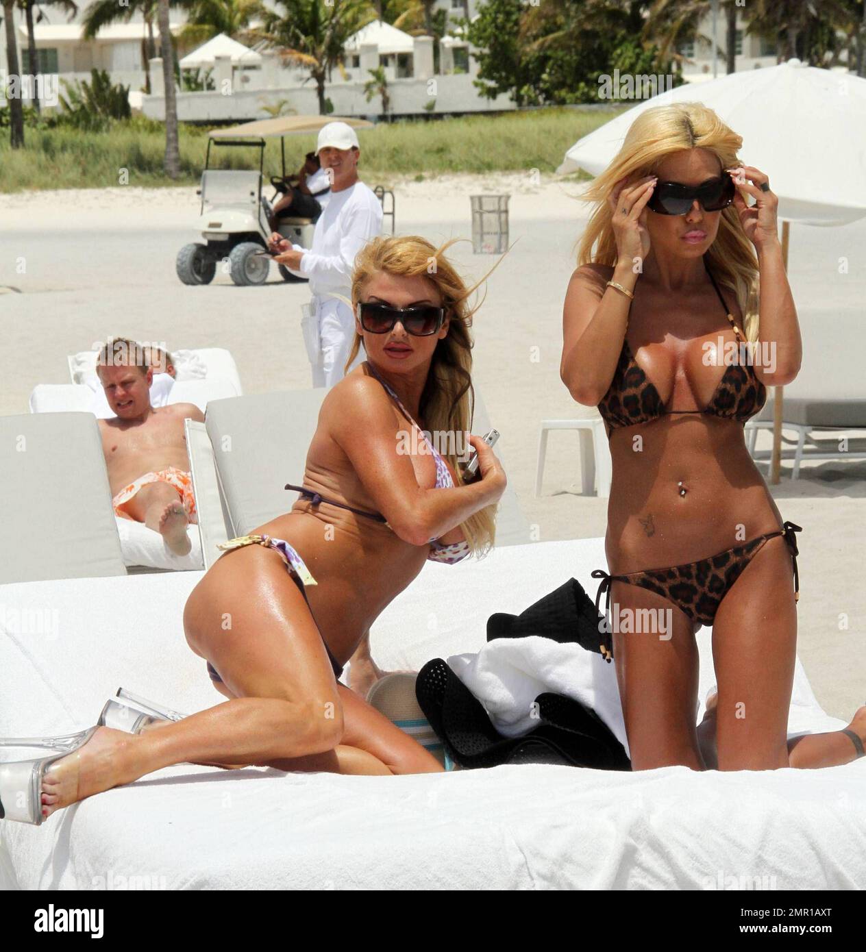 Shauna Sand and Playboy Radio Host, Taylor Wane, give the photographers and  eyeful in matching lucite heels and bikinis while enjoying a day at the  beach ahead of annual EXXXOTICA Expo which
