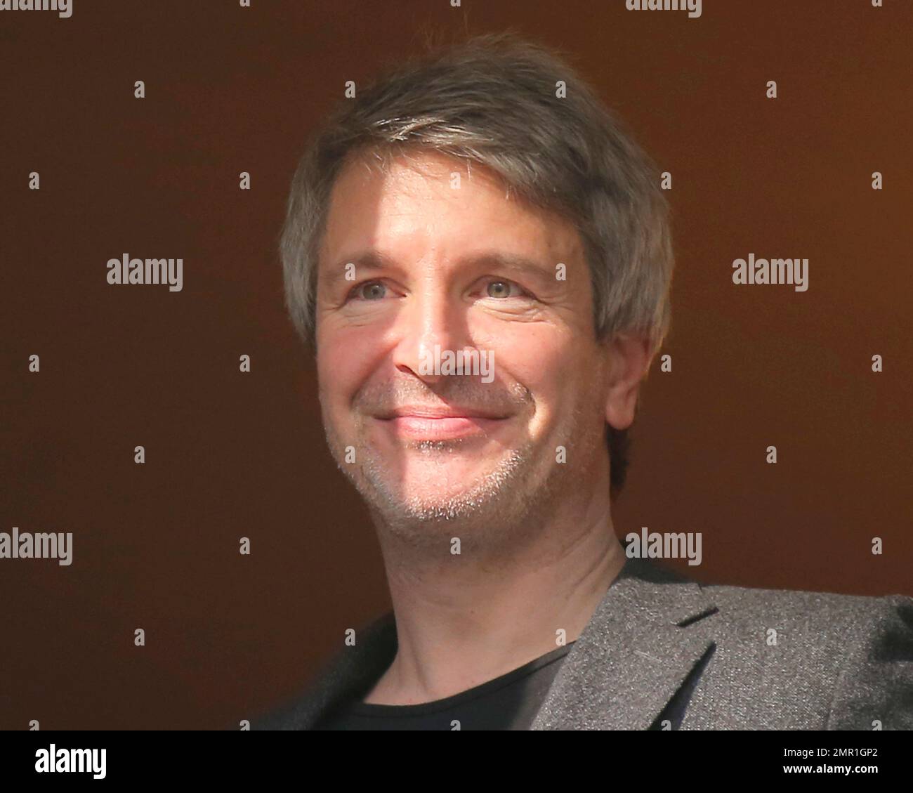 French writer Eric Vuillard appears at the window of the restaurant