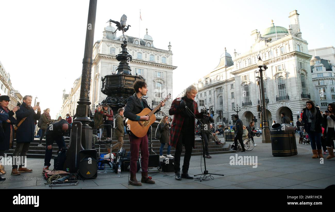 British rock star Rod Stewart with singer Henry Facey sing a version of
