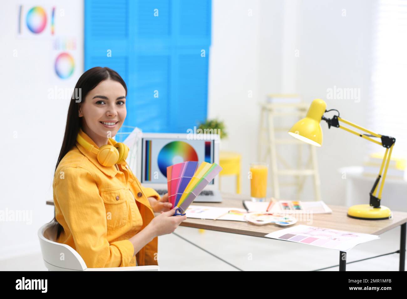 Female designer working at desk in office Stock Photo - Alamy