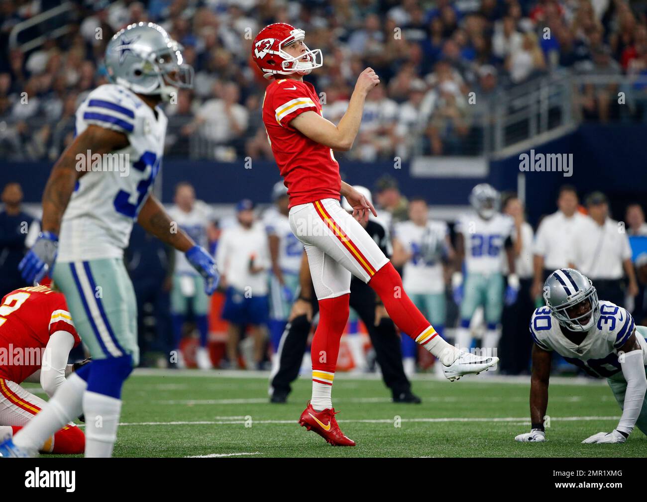 Kansas City Chiefs' Harrison Butker (7) and Dallas Cowboys' Anthony Brown watch Butker's field