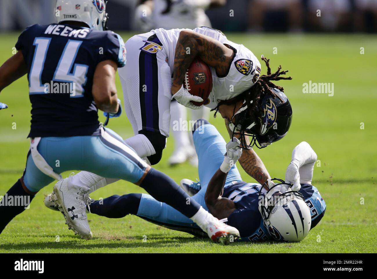 Tennessee Titans cornerback Brice McCain (23) grabs Baltimore Ravens wide  receiver Chris Moore (10) by the face mask in the first half of an NFL  football game Sunday, Nov. 5, 2017, in