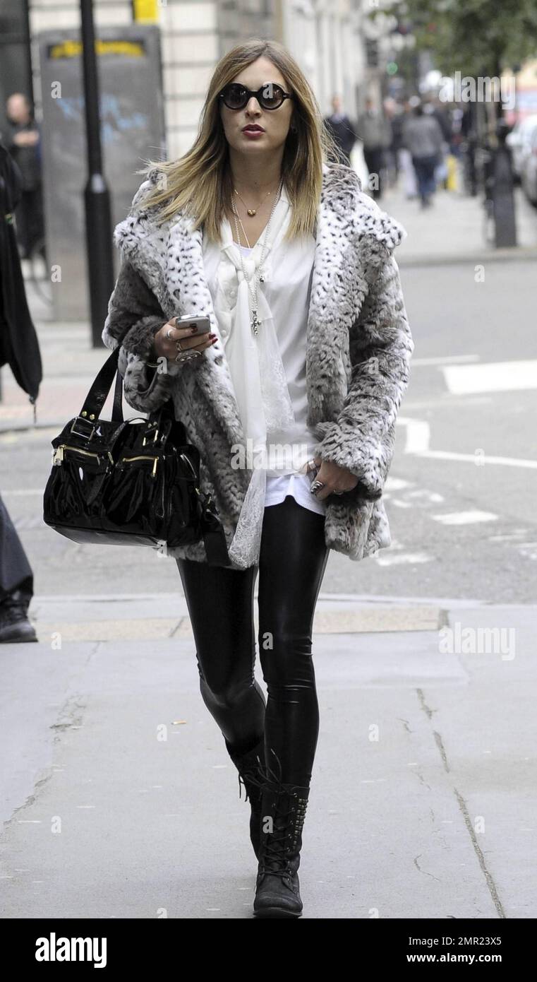 Fearne Cotton wears a very hip outfit consisting of a white top with lace  trim and black leggings paired with black boots, a fur jacket, a black  patent leather handbag and big