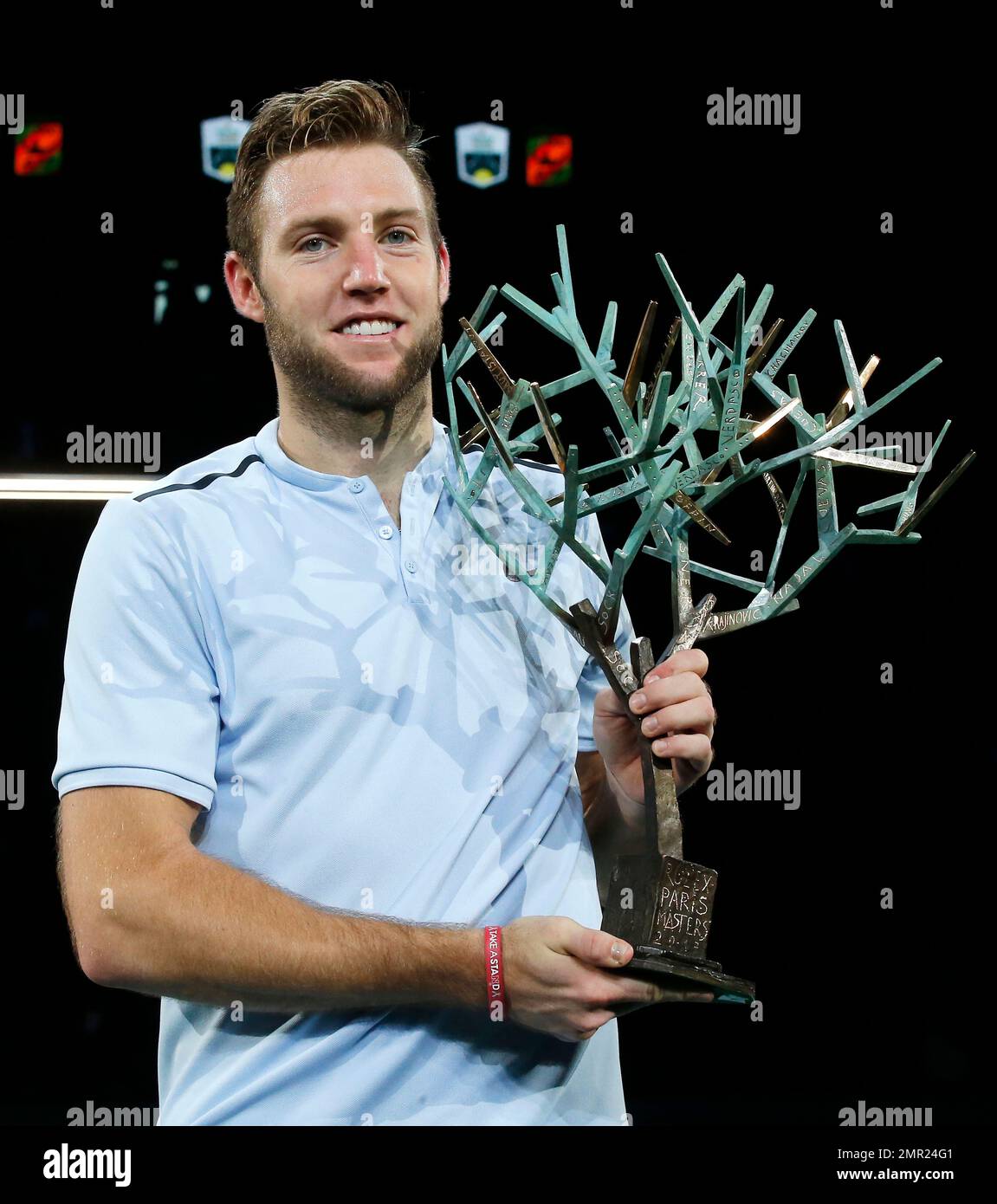 Jack Sock of the United States holds the trophy after he defeated Filip