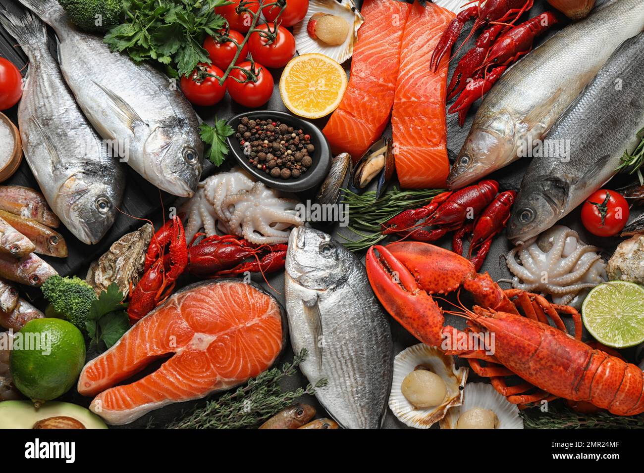 Fresh fish and different seafood on table, flat lay Stock Photo Alamy