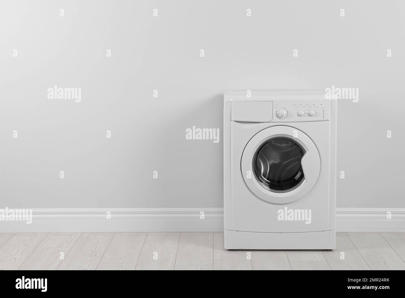 Modern washing machine near white wall, space for text. Laundry day Stock Photo Alamy