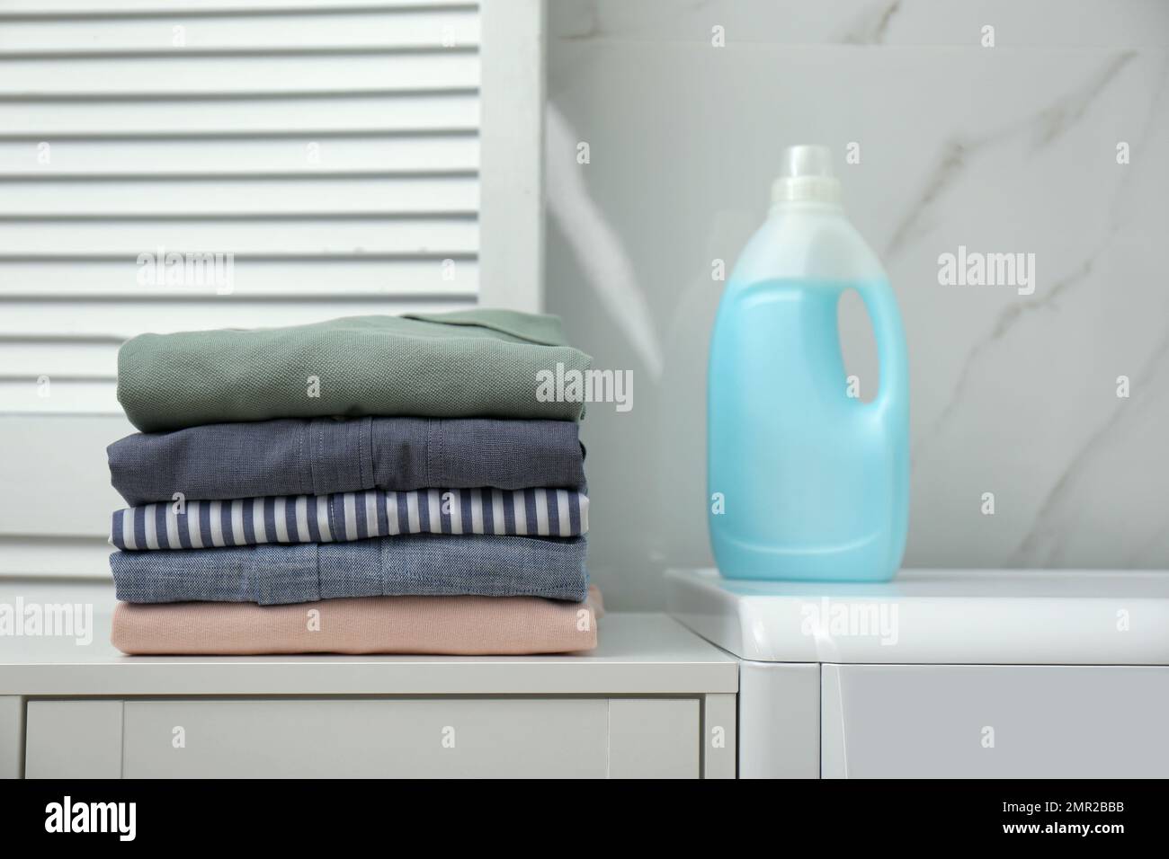 Fresh clean laundry and detergent in bathroom Stock Photo Alamy