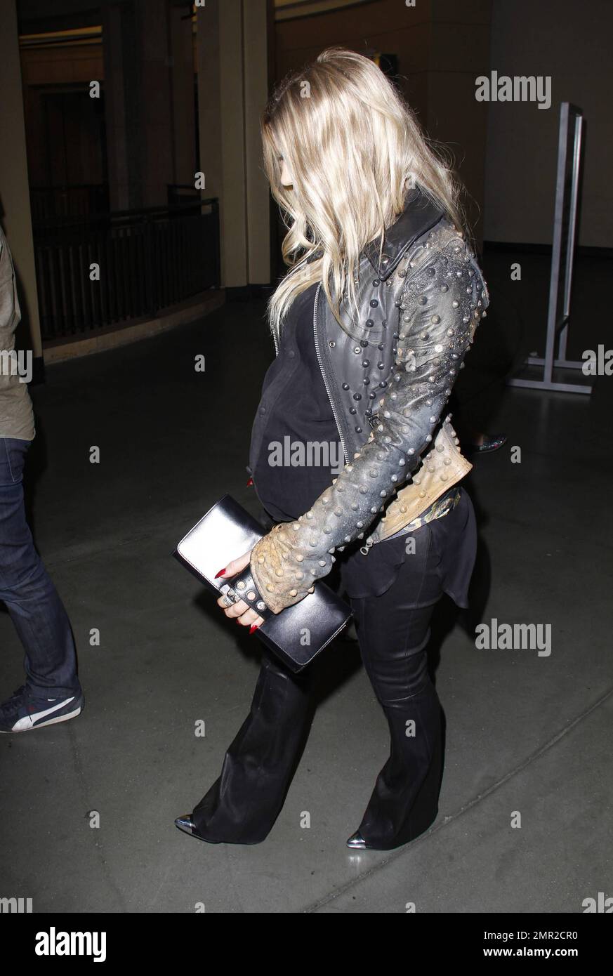 Showing off her baby bump as she awaits the arrival of her first child any day now, Fergie was spotted arriving at the premiere of her husband Josh Duhamel's latest film, "Scenic Route" held at the Chinese 6 Theatre in Hollywood. The 38 year old 'Black Eyed Peas' singer looked amazing in a black studded leather jacket with a sheer black top and black leather pants. Fergie and Josh are reportedly awaiting the arrival of their son at any moment but that did not stop Fergie from coming out to support her hunky husband at his movie premiere. Looking all-aglow, the happy couple appeared in great sp Stock Photo