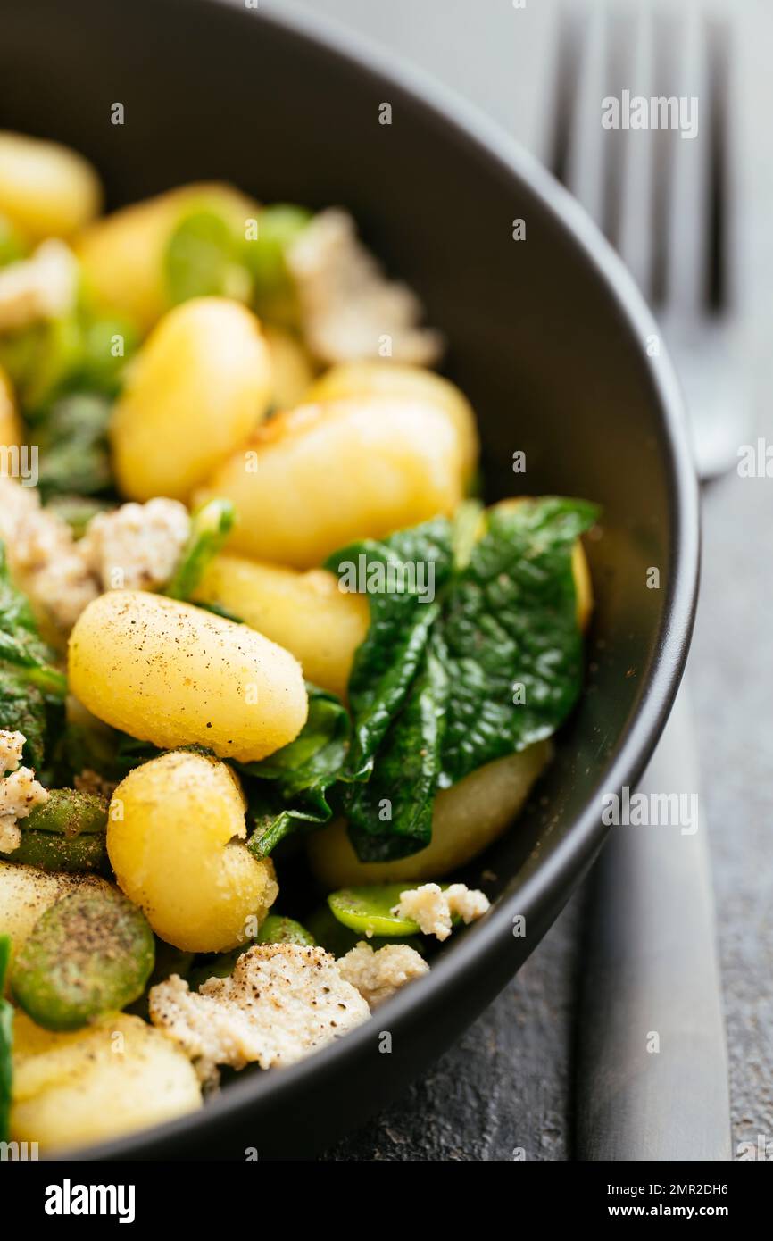 Gnocchi with Fava Beans, Spinach and Home made vegan feta cheese Stock Photo