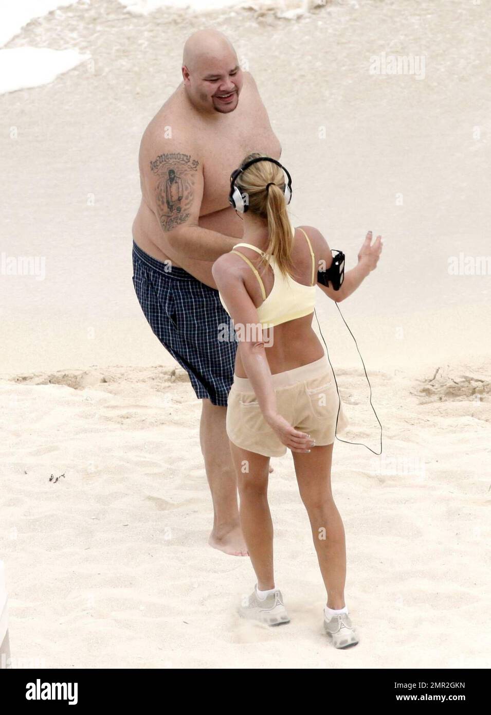 Exclusive!! Fergie goes for a jog on the beach in Mexico to keep her killer curves in shape. The singer bumped into Fat Joe and stoped for a chat with the Latino rapper. Her beau, Josh Duhamel, meanwhile was happy to lay on a lounger with a cocktail instead of working up a sweat. 3/7/07 Stock Photo