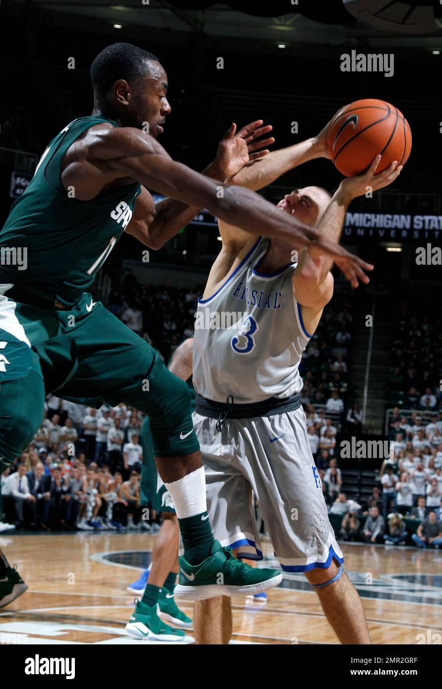 Michigan State's Tum Tum Nairn, left, fouls Hillsdale's Nate Neveau