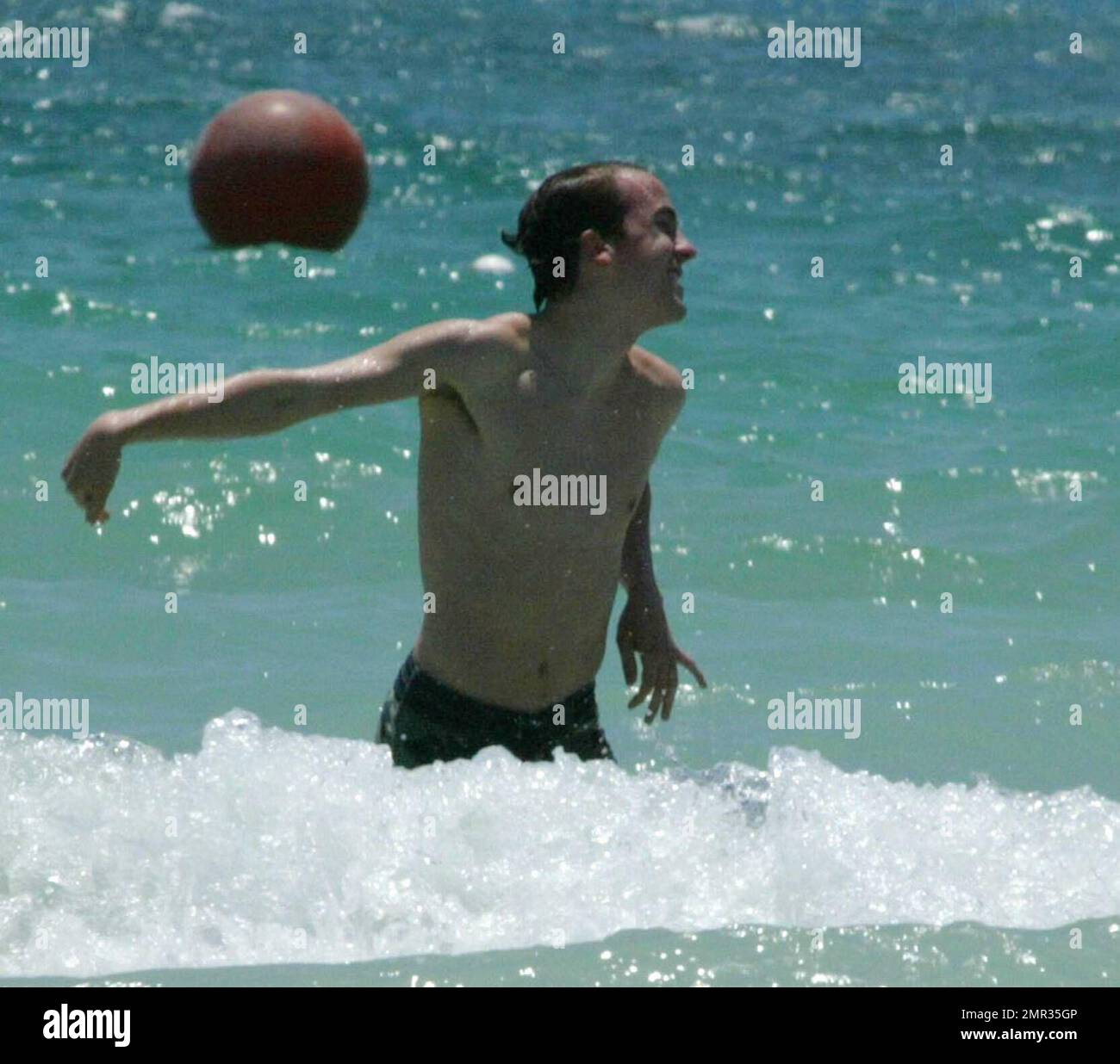 Frankie Muniz and fiancee Jamie Gandy on Miami Beach. Frankie played in the surf before walking his gal back to their hotel during the filming of Frankies new movie "My Sexiest Year". 5/5/06 Stock Photo