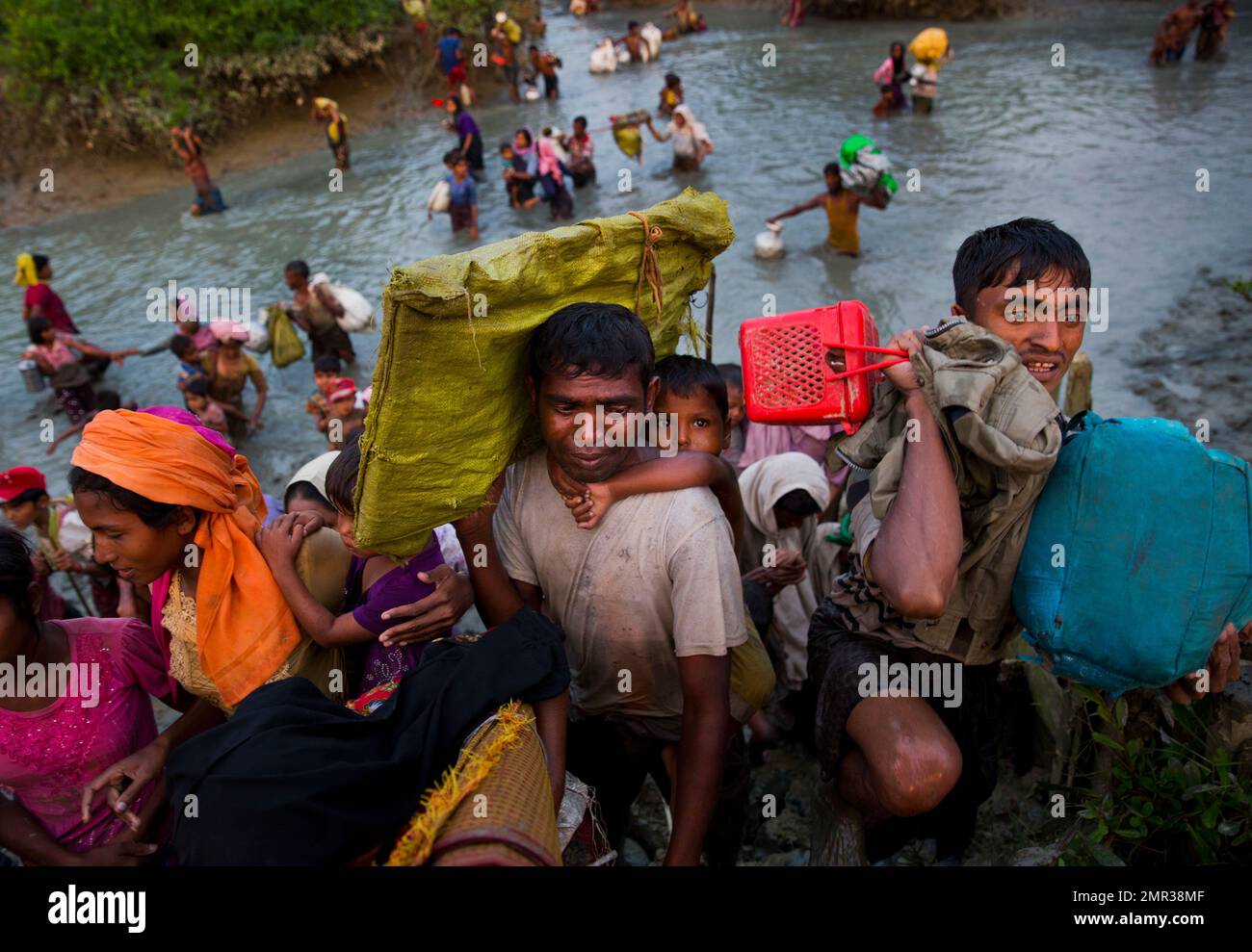 Rohingya Muslims cross the border from Myanmar into Bangladesh, near