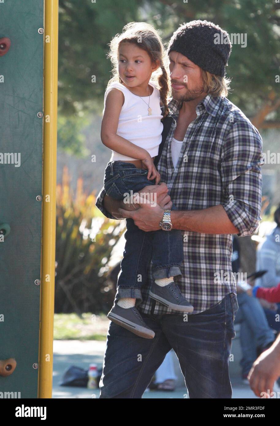 Wearing matching outfits, Gabriel Aubry and daughter Nahla spend a day together at a local playground. Joined by a friend, little Nahla played on the swings and her dad carried her while toting along her scooter and helmet. Aubry and Nahla's mom Halle Berry share legal custody, but it's reported that he lost the most recent battle after a judge refused his request to rescind a requirement that a nanny be present during his custody visits. Beverly Hills, CA. 28th December 2011. Stock Photo