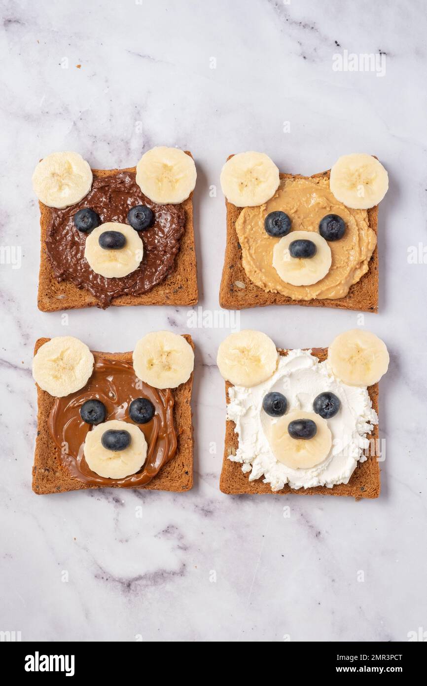 Breakfast toasts with nut butter and banana with cute funny bear face
