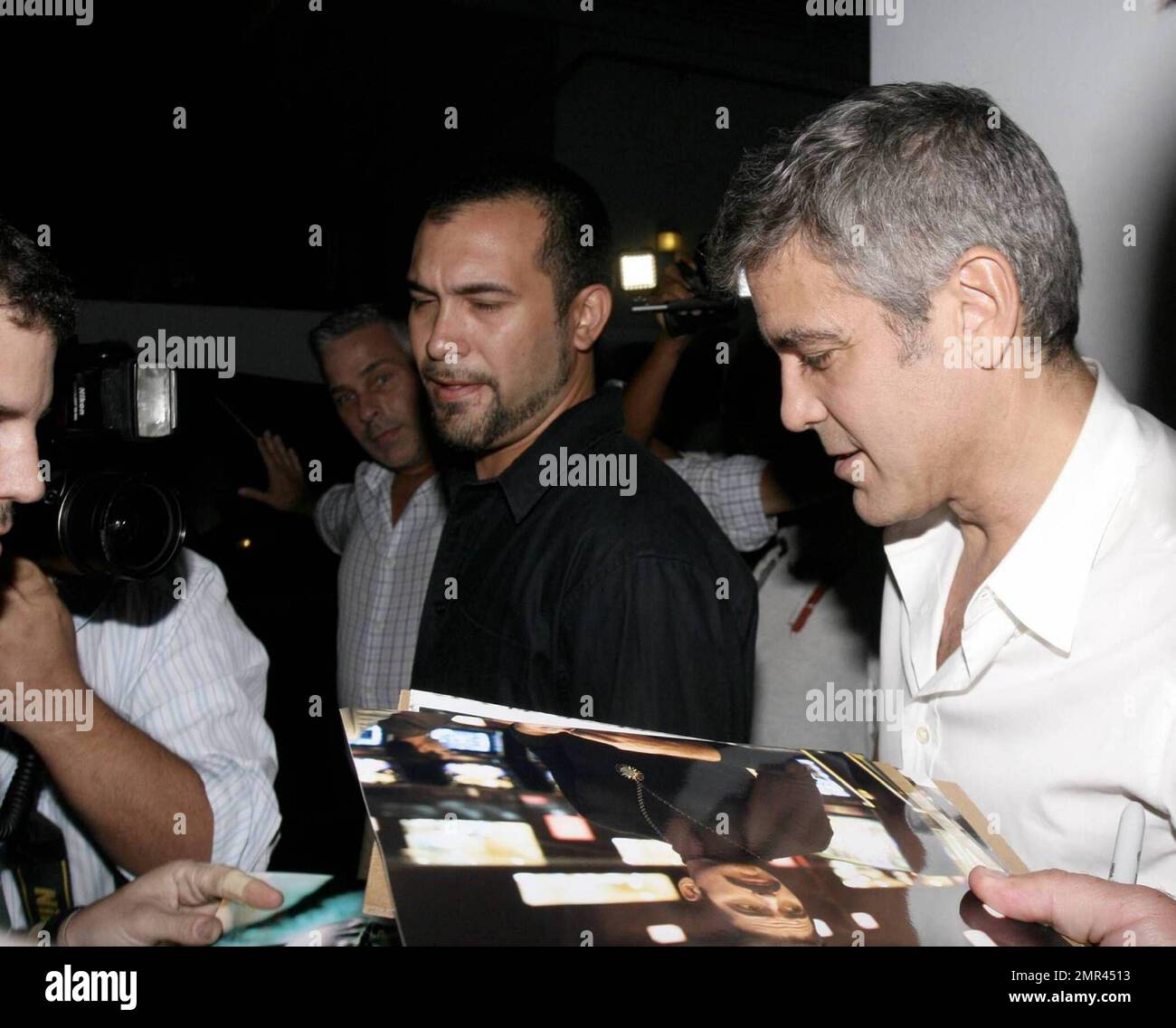 Actor George Clooney signs some night-time autographs before hitting ...