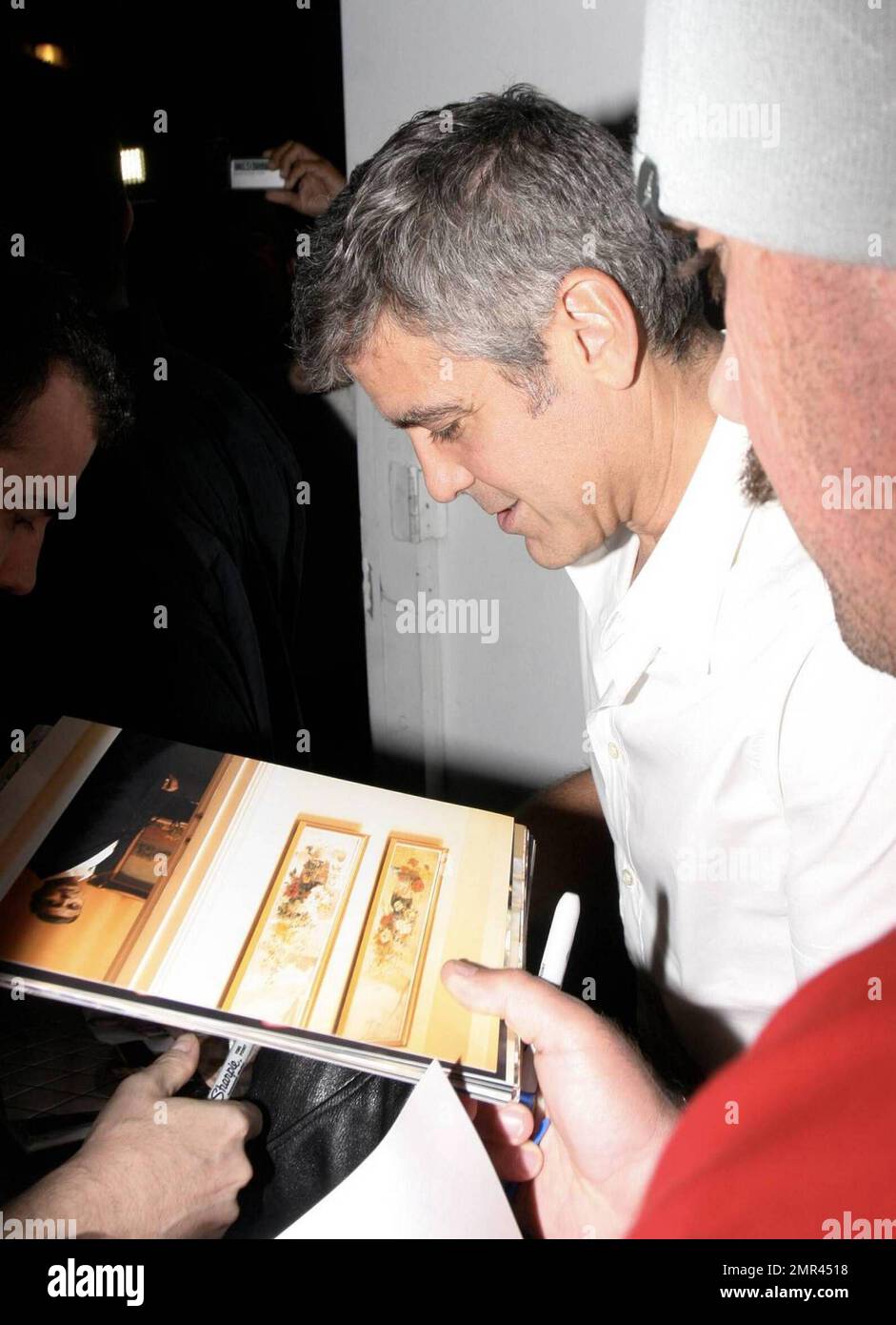 Actor George Clooney signs some night-time autographs before hitting ...